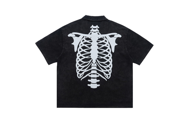 Black washed polo shirt with a large white skeleton spine graphic on the back and short sleeves