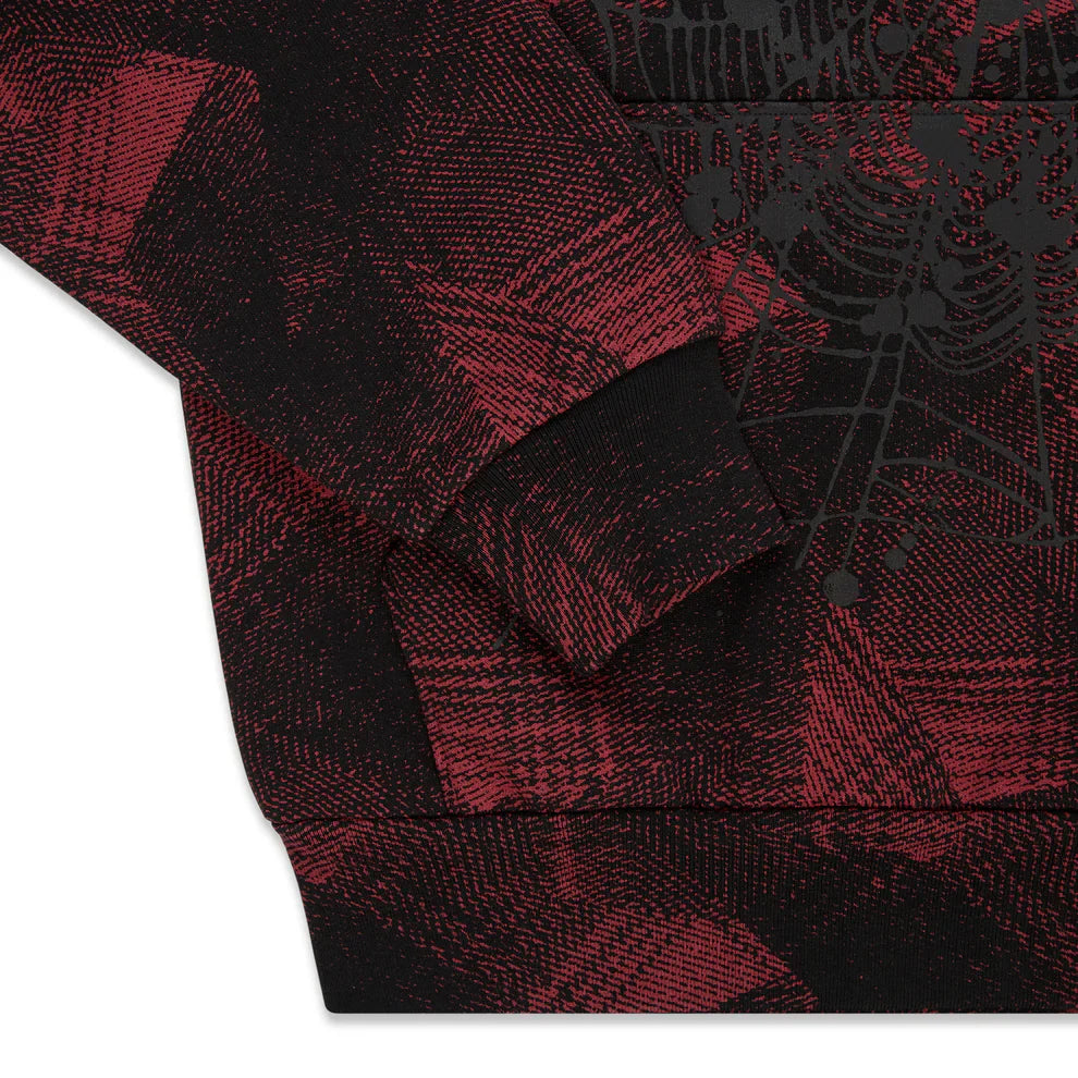 A close-up of the Red and Black Graphic Hoodie with Star Detail and Spider Web Print, highlighting its abstract patterned fabric, intersecting lines, and comfort fit pullover style—showcasing sleeve and hem details.