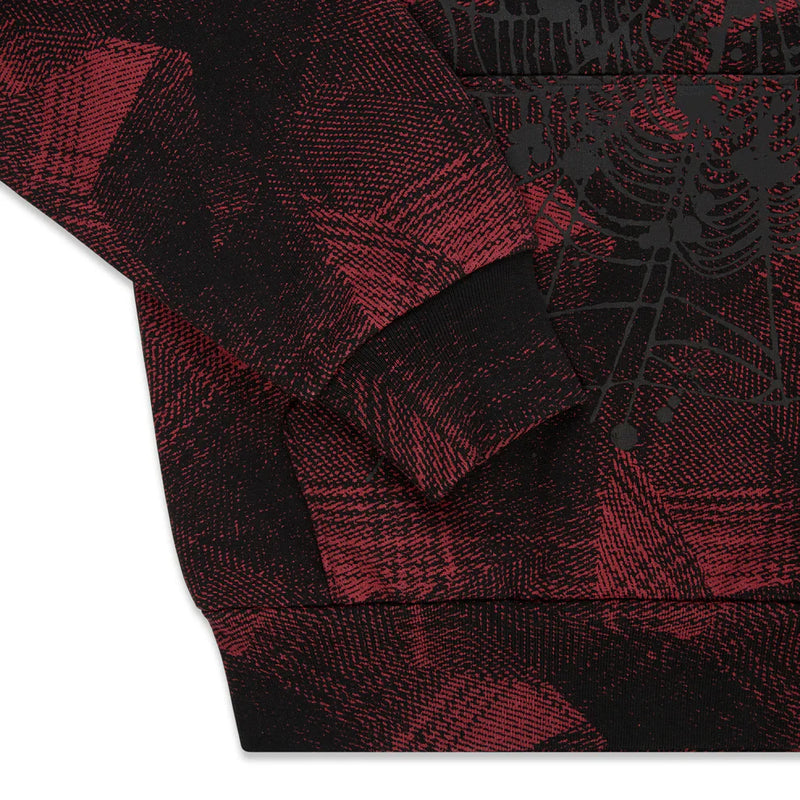 A close-up of the Red and Black Graphic Hoodie with Star Detail and Spider Web Print, highlighting its abstract patterned fabric, intersecting lines, and comfort fit pullover style—showcasing sleeve and hem details.