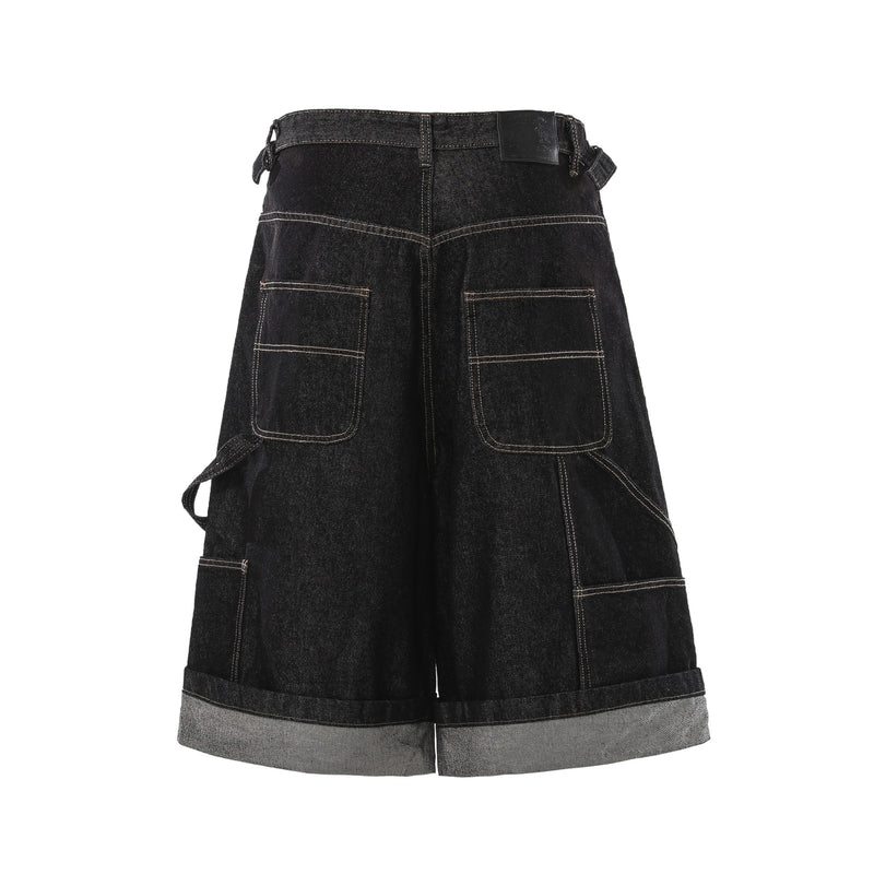 Back view of black denim cargo shorts with large patch pockets and raw cuff
