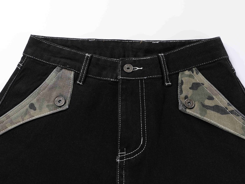 Top front waistband of black jeans with camouflage pocket trim and white stitching
