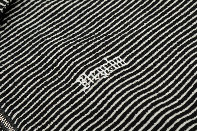 Close-up of black striped chest logo on the hoodie