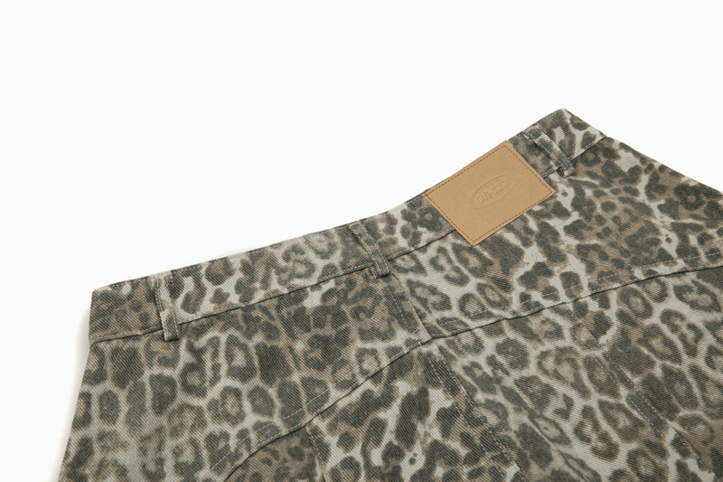 Close-up of back waistband with tan label patch on leopard print denim