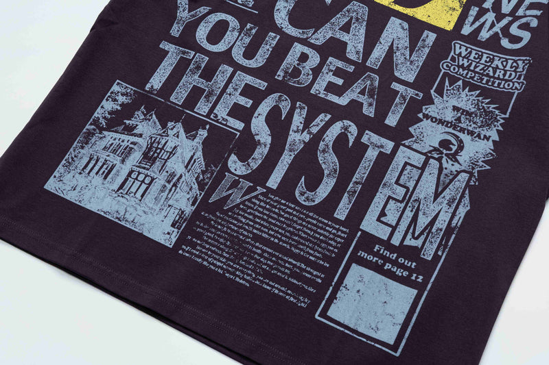 Black oversized graphic tee with distressed newspaper-style print and bold Lucky System text in Y2K streetwear style