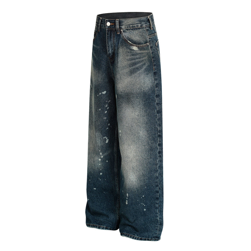 Three-quarter front view of wide-leg paint-splatter jeans in dark blue wash