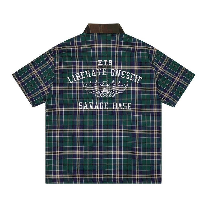 Green and navy plaid short-sleeve shirt with camo collar and bold Savage Base graphic on the back