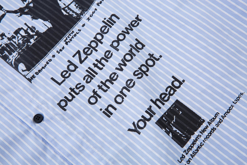 Close-up of printed text on the front of a light blue pinstripe shirt