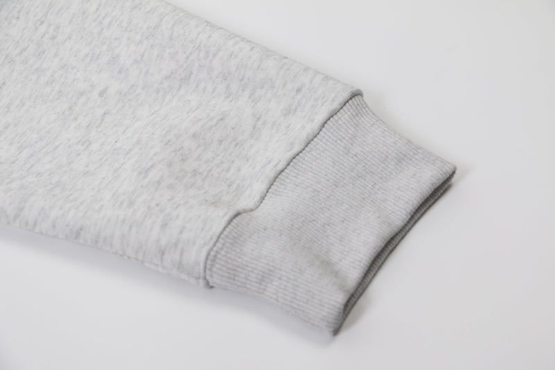 Close-up of light gray hoodie sleeve cuff with ribbed knit trim