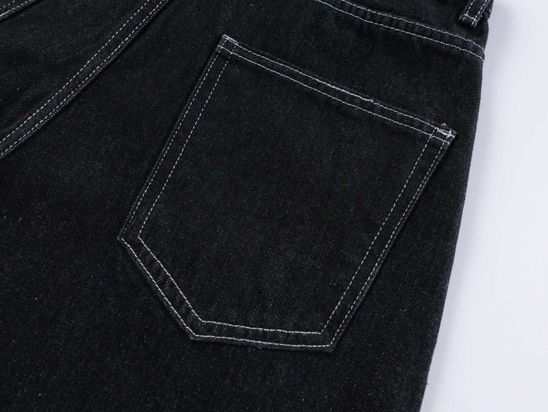 Close-up of the back right pocket on dark wash denim shorts