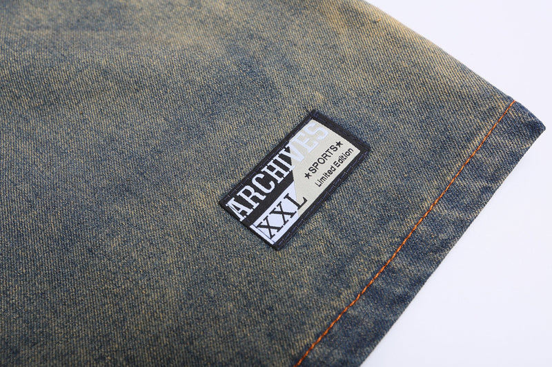 Close-up of vintage denim jersey tee with ARCHIVES patch and orange contrast stitching