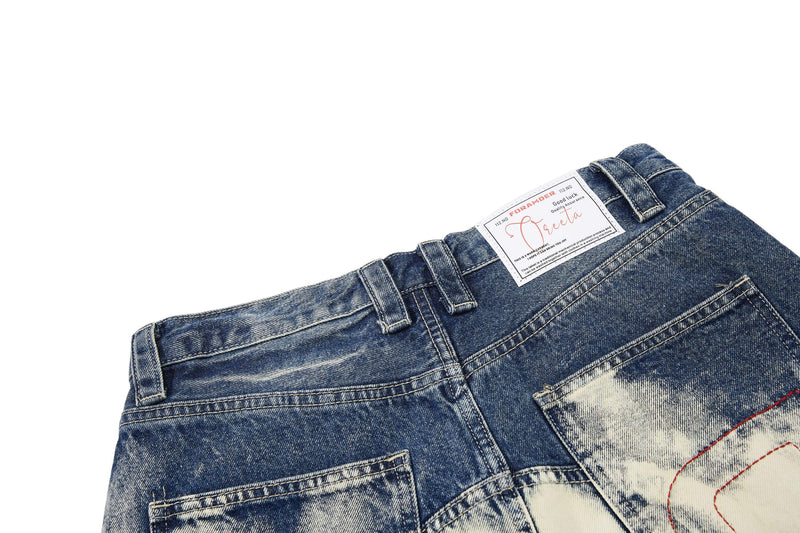 Back waistband close-up showing belt loops, topstitching, and brand label on denim jeans