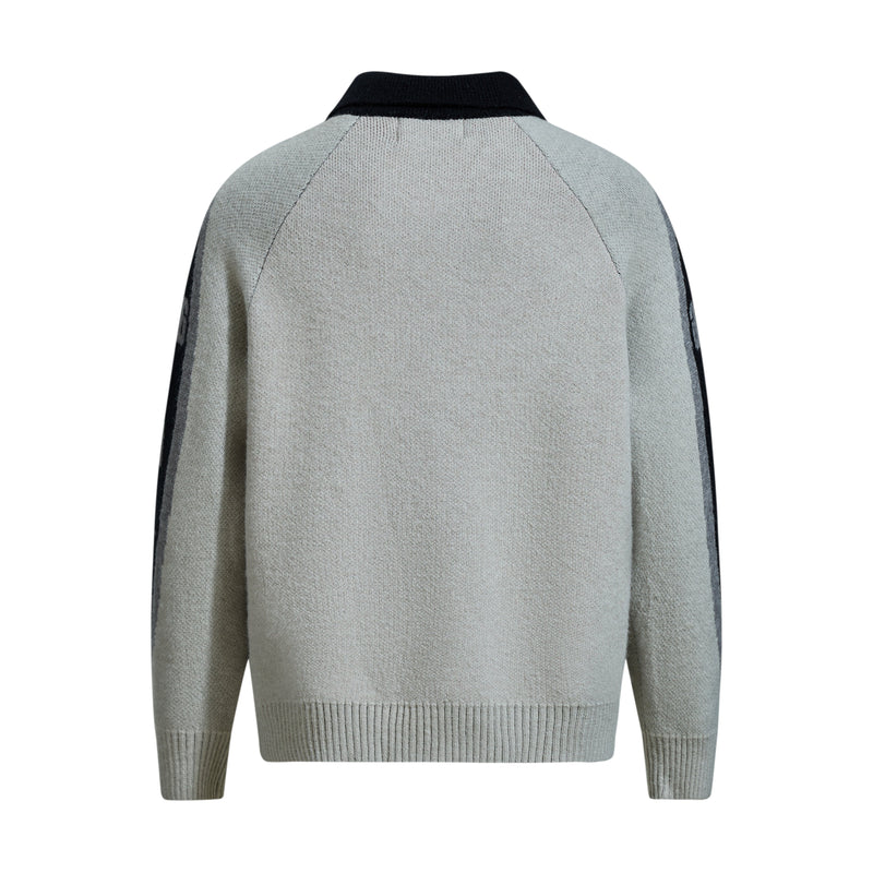 Back view of cream knit sweater with black collar and pale gray colorblock sleeves