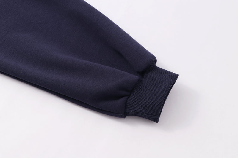 Navy sleeve cuff close-up with ribbed wrist trim