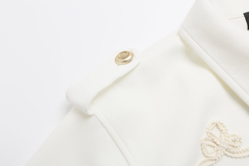 Cream polo shirt with gold epaulette button and braided rope embroidery detail