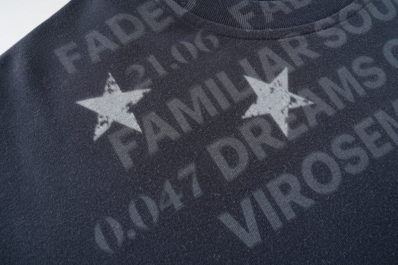 Dark navy faded graphic T-shirt with distressed star print and washed studio logo design on the chest