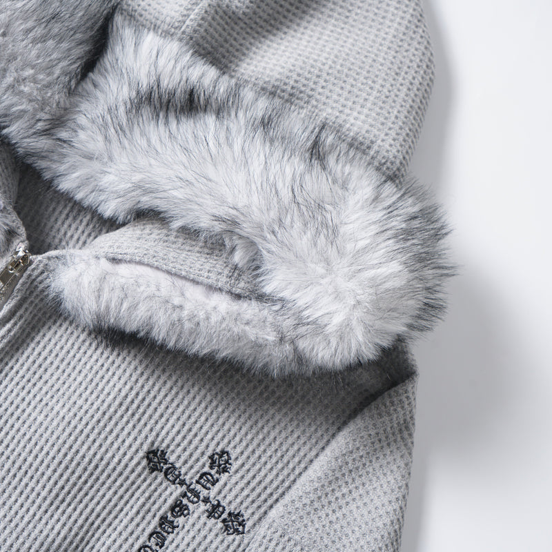 Close-up of the faux fur hood trim and gray waffle knit fabric on the hoodie