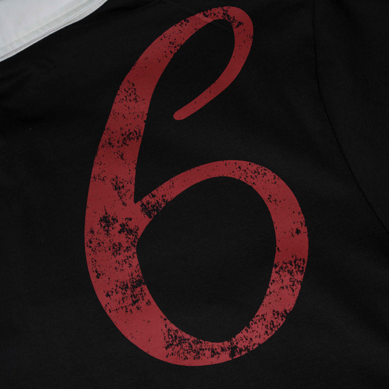 Black graphic polo tee with large distressed red number print and white contrast collar detail