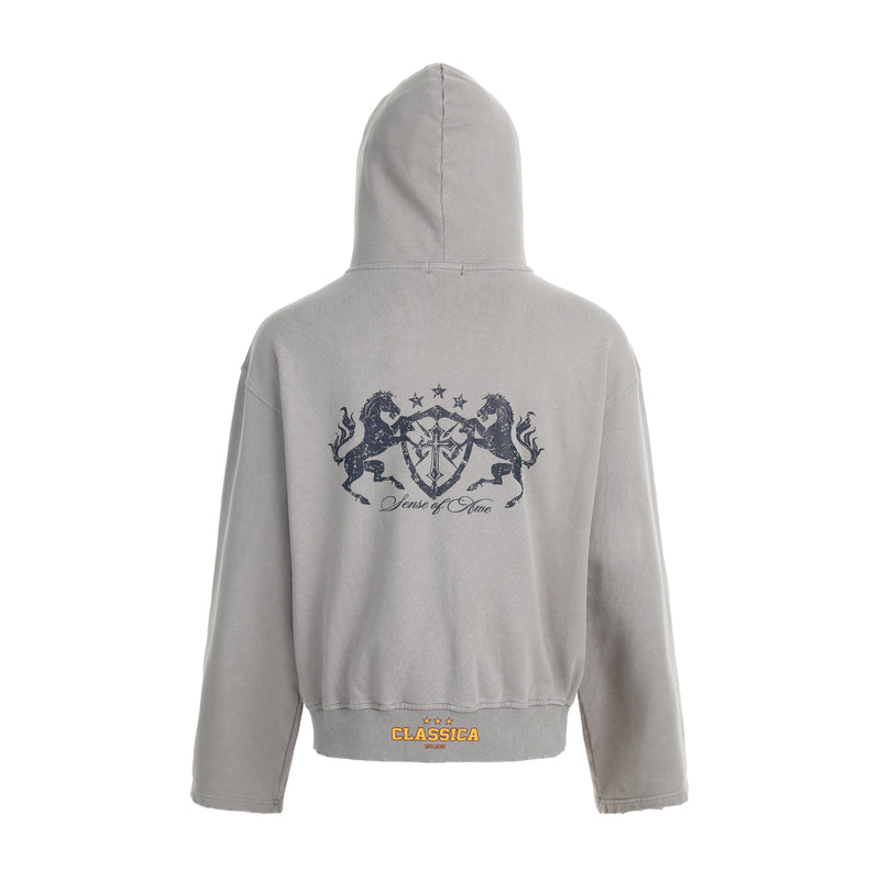 Light gray washed hoodie back view with dark crest graphic and ribbed hem