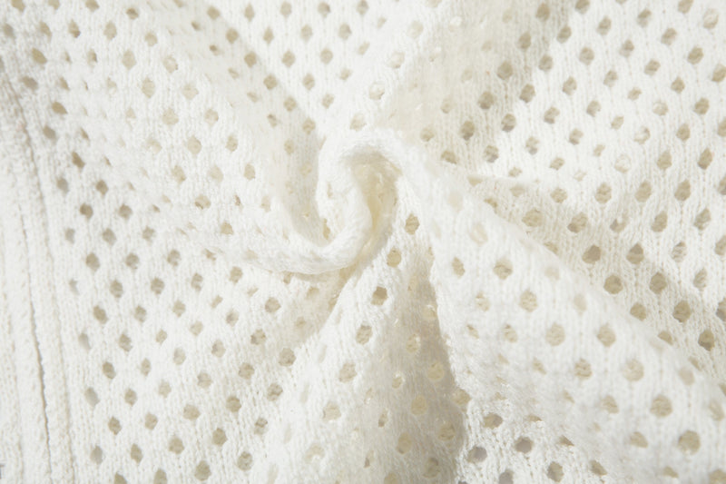 Close-up of white open-knit fabric with soft textured surface