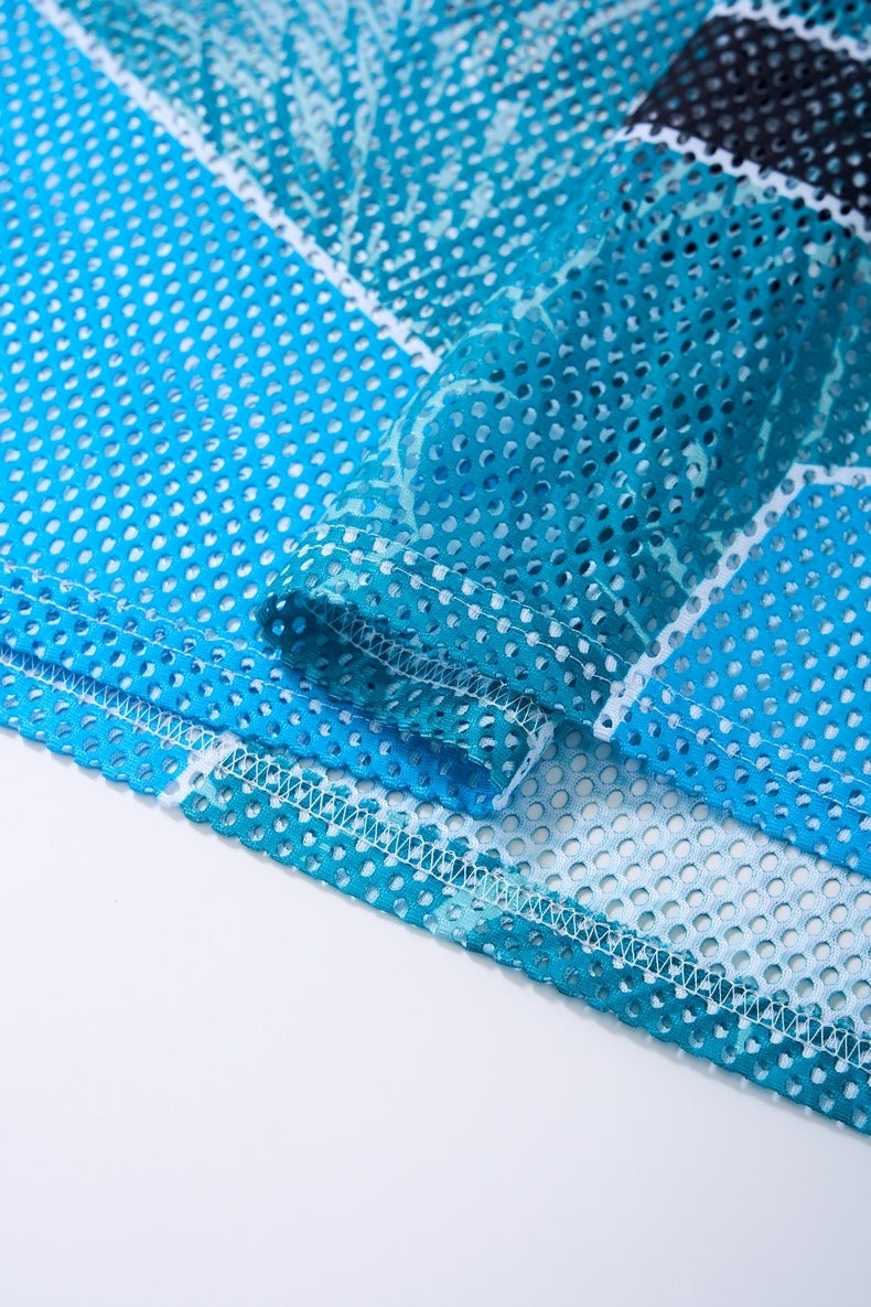 Close-up of a blue mesh jersey T-shirt sleeve and hem with perforated athletic fabric and stitched seams