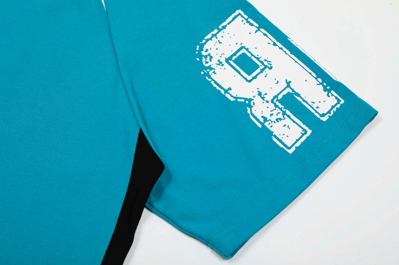 Turquoise varsity T-shirt sleeve with distressed white number graphic and stitched hem detail