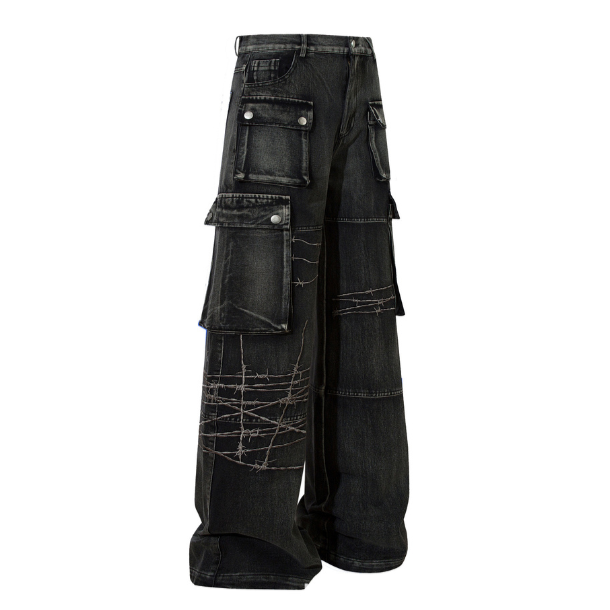 Faded black wide-leg cargo jeans with barbed-wire contrast stitching and oversized snap-pocket detail, side view