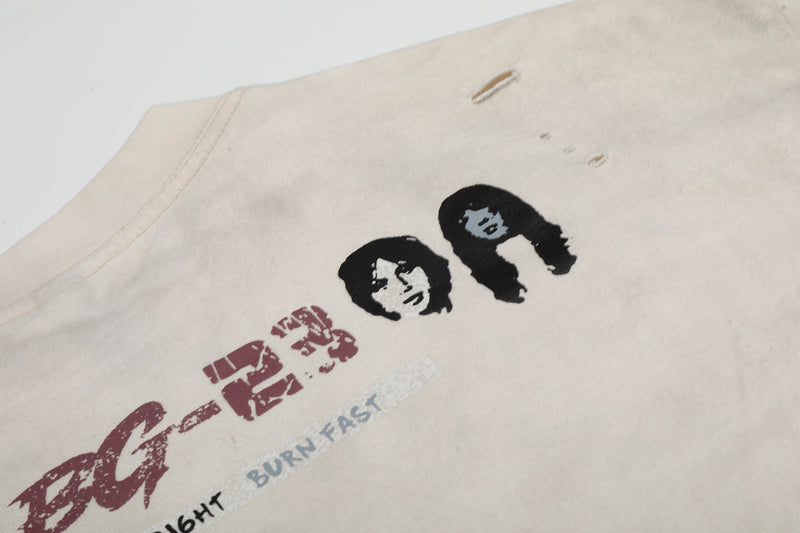 Vintage distressed band tee in cream with worn graphic faces and faded rock text details