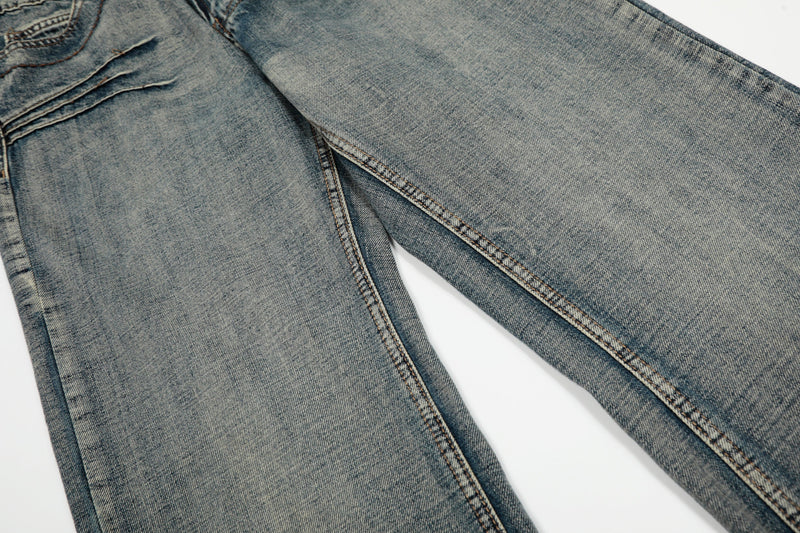 Close-up of the thigh area on wide-leg denim jeans with a light vintage wash