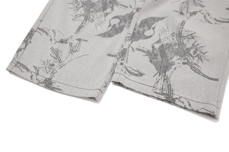 Close-up of the lower pant legs and hems on gray wide-leg printed jeans