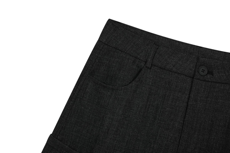 Close-up of black cargo pants front pocket, belt loop, and buttoned waistband