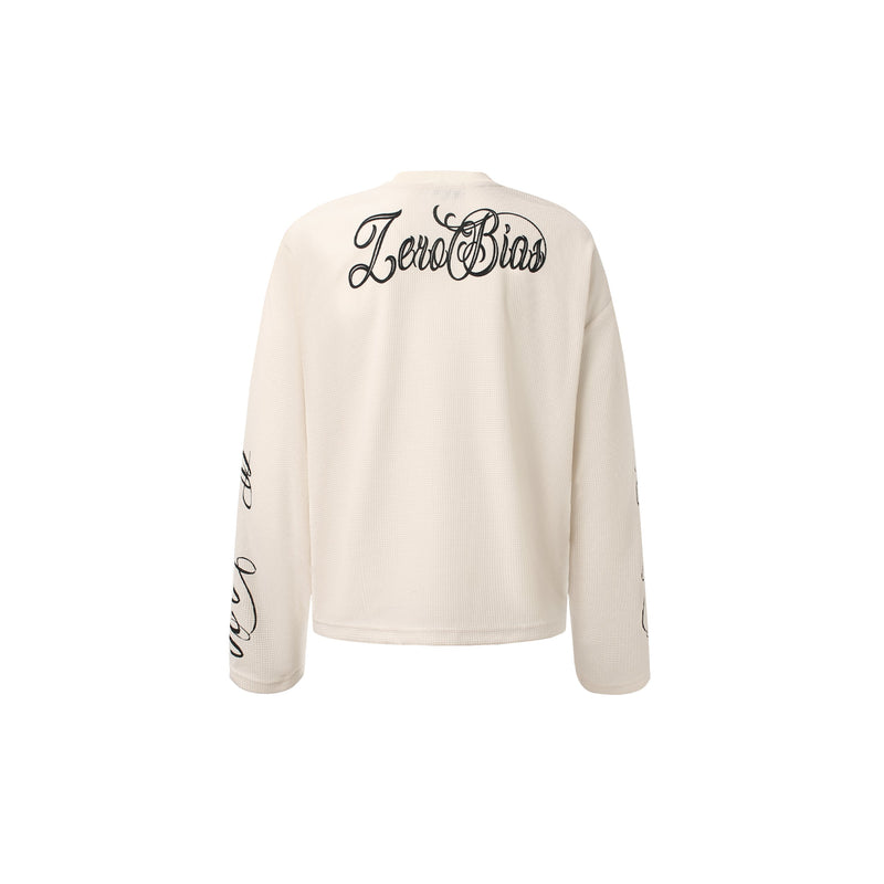 Cream waffle knit long sleeve top back view with Zero Bias script across the shoulders