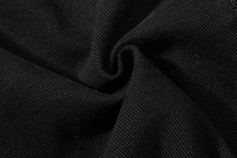 Close-up of black fabric texture with soft twill weave and fold