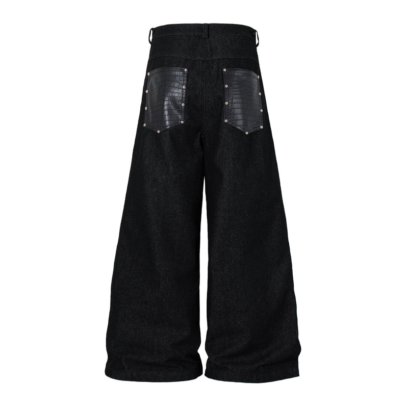 Black wide-leg denim pants with rivets, back view with crocodile-textured pocket panels