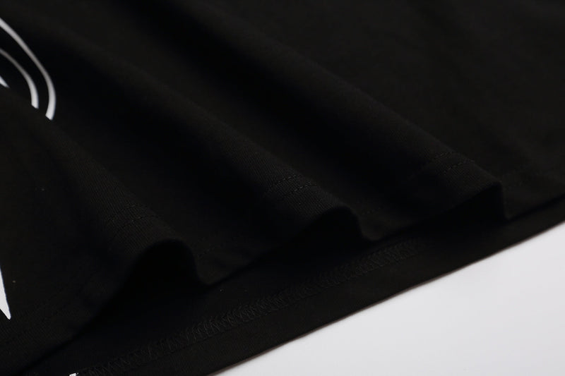 Black polo shirt with a subtle gothic cross print and textured collar detail in Y2K streetwear style