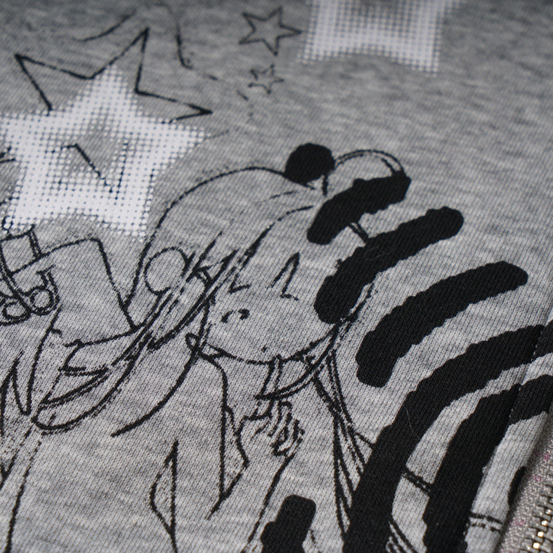 Close-up of printed stars and illustrated face on gray hoodie fabric