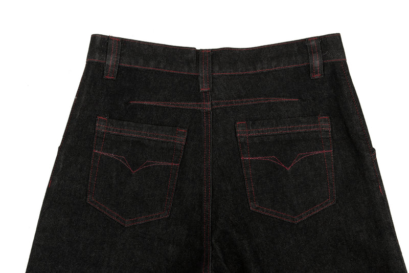 Back waist and pockets of black wide leg denim pants with red contrast stitching
