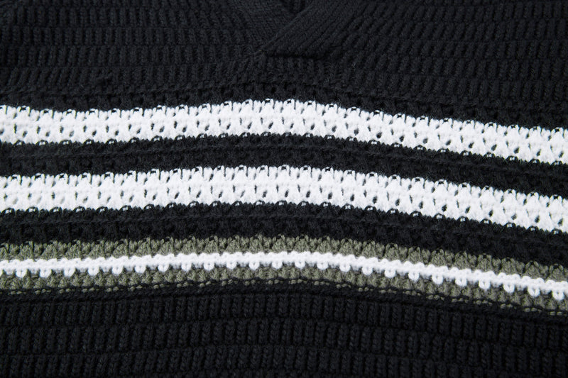 Close-up of white and black striped knit section on the sweater