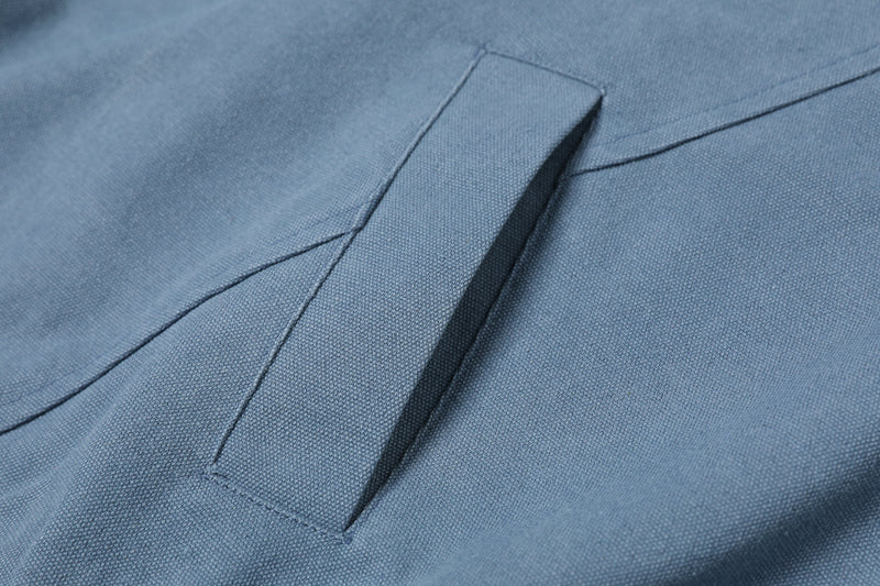 Close-up of blue sweatshirt V-neck collar and stitched front seam