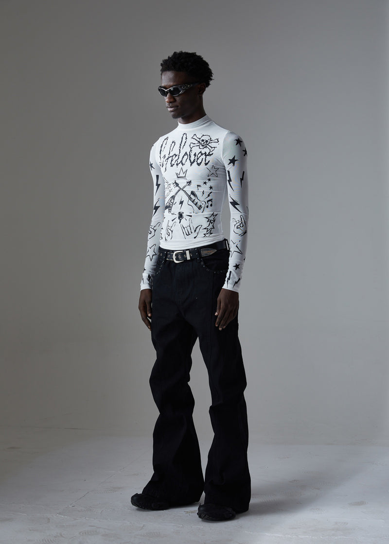 Front three-quarter view of white graphic top with black studded wide-leg jeans