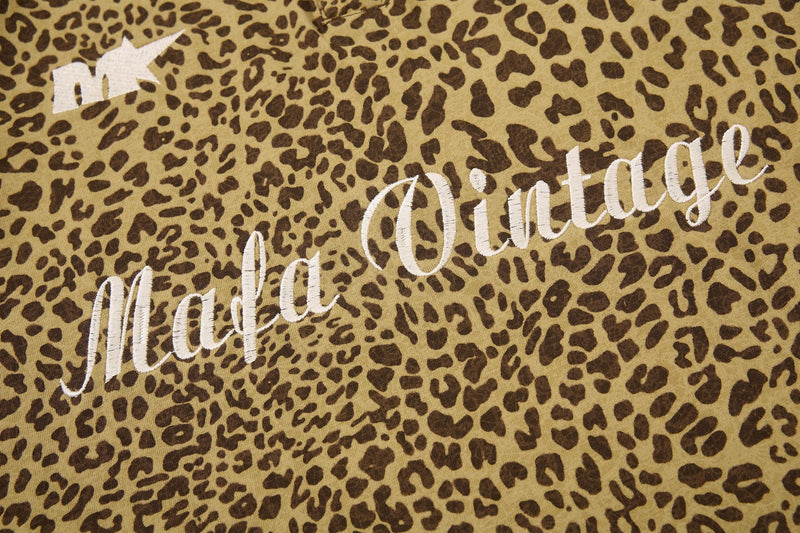 Close-up of a vintage leopard print polo tee with embroidered Mafa vintage lettering in Y2K streetwear style