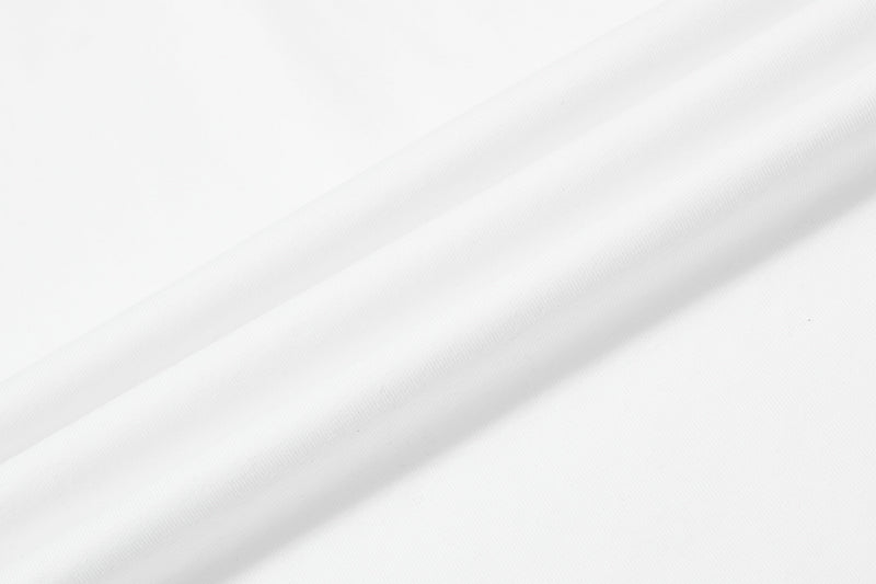 White distressed graphic polo shirt fabric with subtle folds and a clean minimalist close-up texture