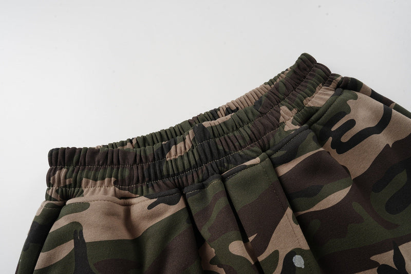 Close-up of the gathered elastic waistband on camo patchwork baggy shorts
