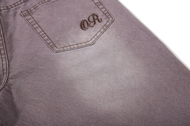 Close-up of brown back pocket with embroidered logo detail