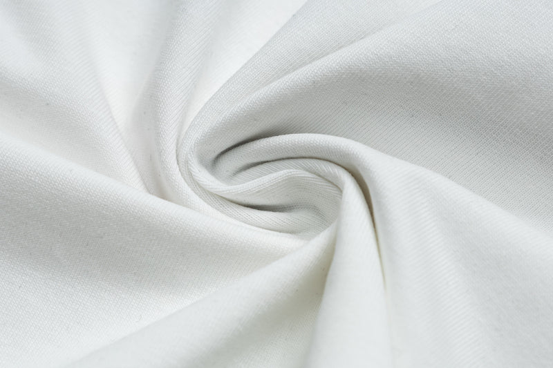 Close-up of white cotton T-shirt fabric with soft folded texture for a vintage rock graphic tee