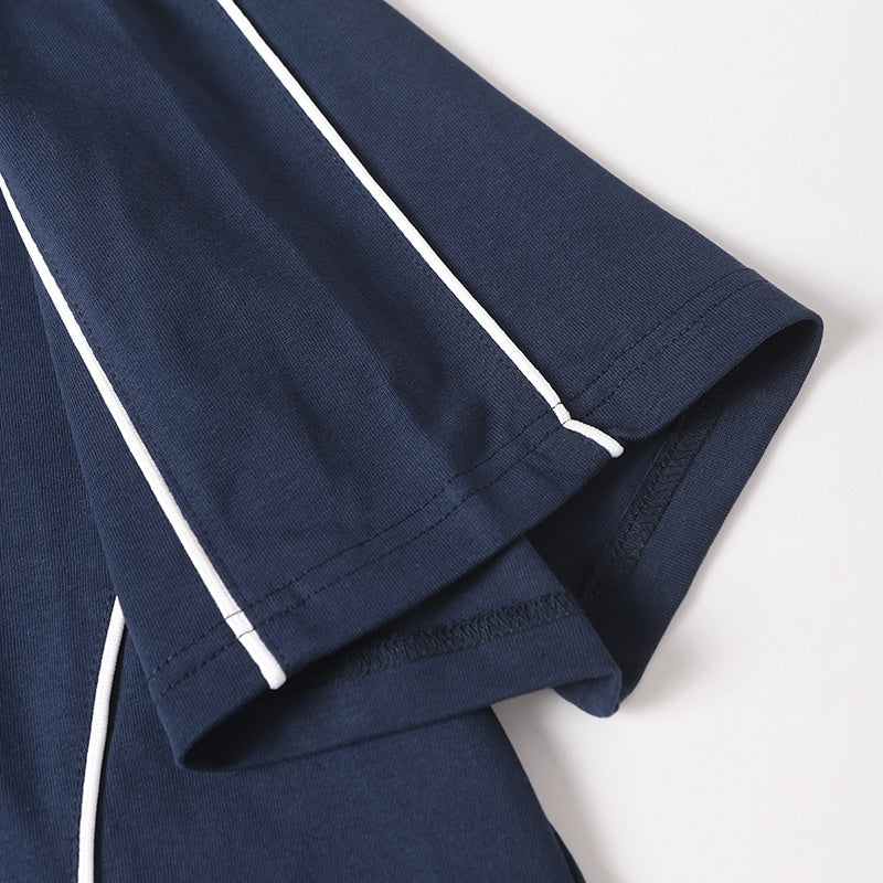 Navy cotton tee with white piping and folded short sleeve, showing athletic streetwear detailing and stitched hem