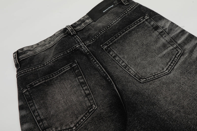 Close-up of the jeans back pockets and waistband on black washed denim