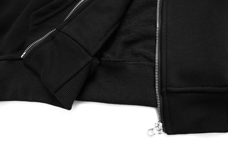 Close-up of black hoodie front hem, zipper, and ribbed waistband