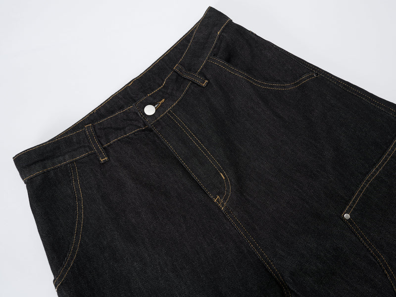 Close-up of dark wash denim waistband with button closure and contrast stitching