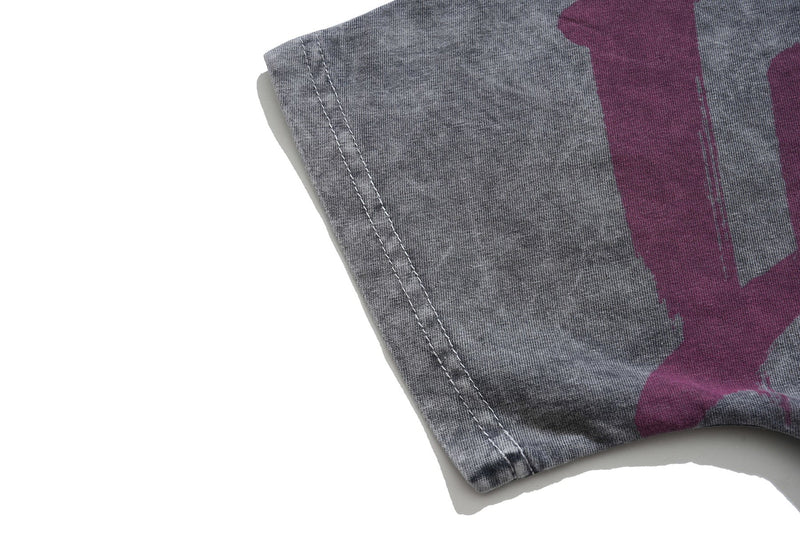 Close-up of a vintage washed gray goth graphic tee sleeve with purple print and visible hem stitching
