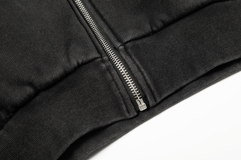 Close-up of black hoodie hem and center zipper